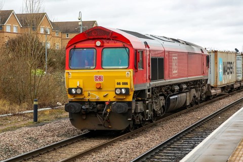 DB Cargo Class 66 freight train passing through Peterborough railway station, Cambridgeshire,