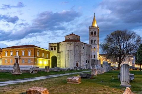 The Church of St Donatus, remains of the Roman forum and the bell tower of Zadar Cathedral at dusk,