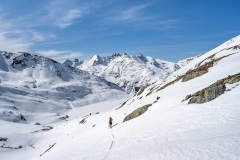 Ski tourer in mountain landscape with snow, ascent to Grialetsch Scharte, Bündner Haute Route,