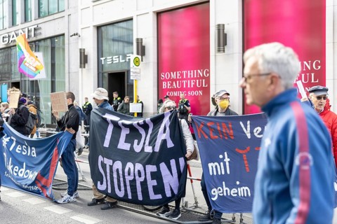 Berlin, Germany - 5 April 2025: People demonstrate in front of a Tesla shop in Berlin against Tesla