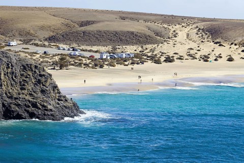 Papagayo beach with blue sea and dunes in a secluded coastal landscape, Playa Blanca, Lanzarote,