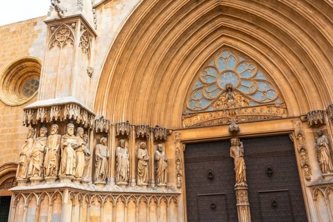Statues of saints decorating the richly adorned main entrance of tarragona cathedral, a stunning