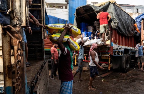 GUWAHATI, INDIA - MAY 1: Labourers carries goods in a wholesale market, in Guwahati, India, on May