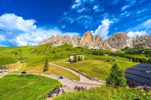 Breathtaking view of the majestic dolomites group mountains and the winding road of passo gardena