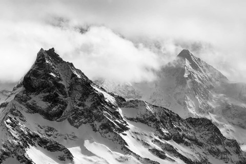 Fog envelops the snowy summit of the mountain Le Besso, Val d'Anniviers, Valais Alps, Canton
