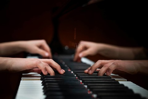 Hands of a young pianist playing on the keyboard of a Steinway & Sons grand piano, Stuttgart,