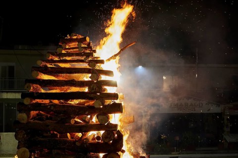 A large pile of wood burns brightly and is surrounded by flames, Easter bonfire Psinthos, Holy