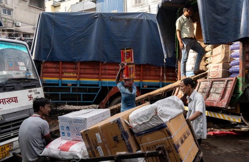 GUWAHATI, INDIA - MAY 1: Labourers carries goods in a wholesale market, in Guwahati, India, on May