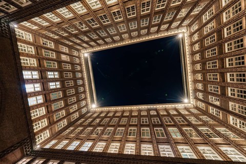 Impressive perspective of the Chilehaus at night, illuminated entrance and brick façade, Hamburg,