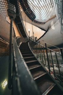 Architectural view of a wooden staircase under a net at a lofty height, old Elbe tunnel, Hamburg,