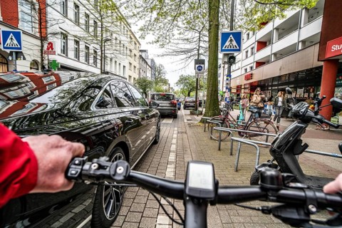 Cycling in the city, inner-city street, cycle lane, bicycles have priority, two-lane traffic with