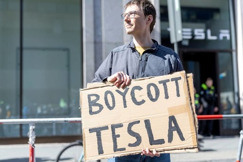 Berlin, Germany - 5 April 2025: People demonstrate against Tesla owner Elon Musk in front of a