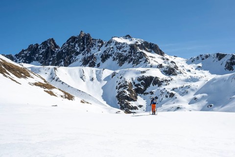 Ski tourers on the Graubünden Haute Route in the Val Susauna mountain valley, snow-covered