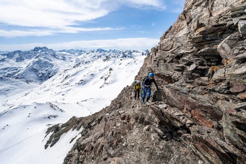 Two mountaineers climbing up a narrow mountain path, ascent to the summit of Piz Grialetsch in