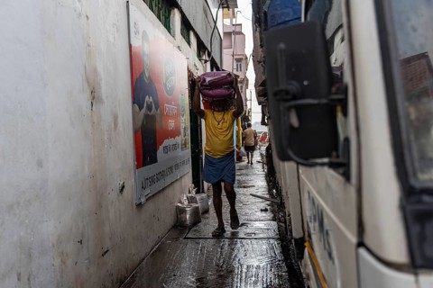 GUWAHATI, INDIA - MAY 1: Labourers carries goods in a wholesale market, in Guwahati, India, on May