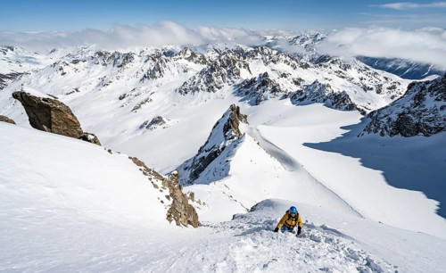Mountaineer with ice axe and crampons, ascent through steep snowfield to Piz Kesch or Piz d'Es-cha
