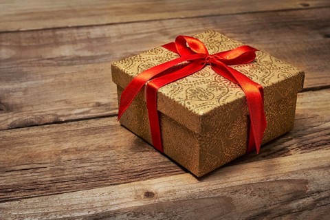 Gift present birthday Christmas concept, gift box with red ribbon on wooden background