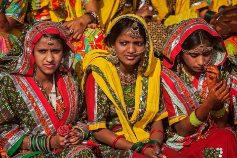 PUSHKAR, INDIA, NOVEMBER 21, 2012: Unidentified Rajasthani girls in traditional outfits prepare for