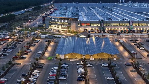 Tesla Giga Factory at the blue hour, centre, photovoltaic system above a charging station for