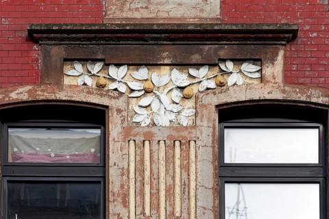 Facade decoration on a Wilhelminian style house for renovation, branches with pears, detail,