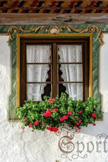 Typical Lüftlmalerei around window with geraniums, Wallgau, Werdenfelser Land, Upper Bavaria,