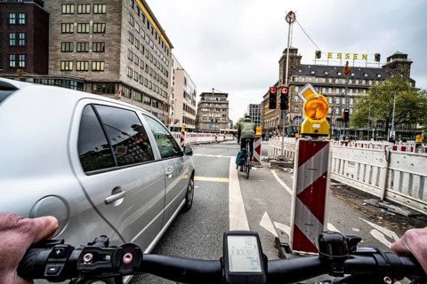 Cycling in the city, city centre road, roadworks, narrowed lanes, cyclists' perspective, Essen,