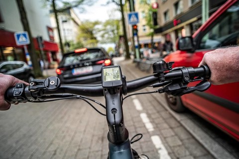 Cycling in the city, inner-city street, cycle lane, bicycles have priority, two-lane traffic with