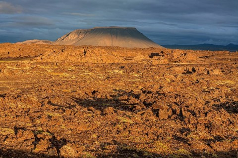 Large lava field and volcanic crater in the midnight sun, clouds, mood, Burfellshraun, Myvatn,