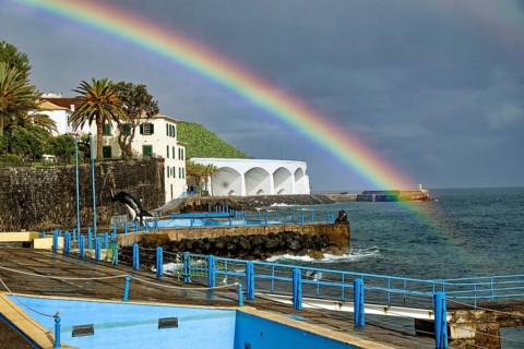 Promenade in rainy weather with rainbow on the beach of the Atlantic Ocean, municipality of Santa