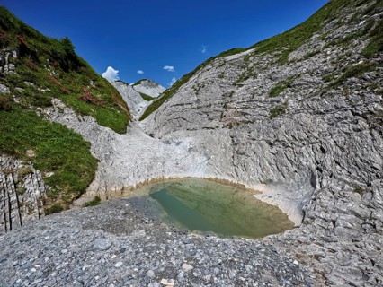 Glacier mill with glacier pots on the Trinser Alp Mora, Trin, Canton Graubünden, Switzerland,