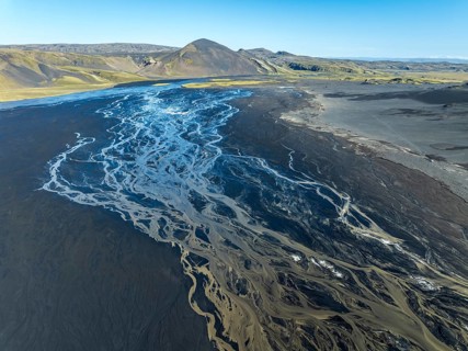 Aerial view, glaicial streams flow across Mælifellssandur, black sand desert, Icelandic highlands,