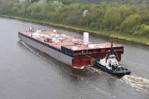 Tugboat pulling ship, ship component Lse Casco Project through the Kiel Canal to Papenburg,