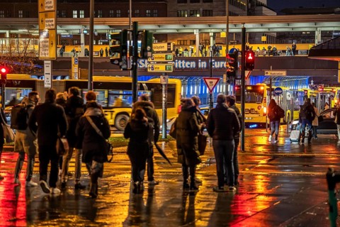 Pedestrian, in rainy weather, at a traffic light, pedestrian crossing, at the main railway station