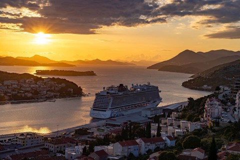 Cruise ship Norwegian Escape in the harbour of Dubrovnik at sunset, Croatia, Europe