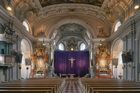 Interior with large purple Lenten cloth in front of the high altar, baroque parish church of St