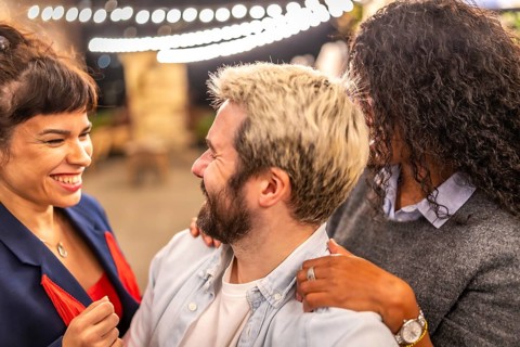 Distracted friends chatting while taking selfies during night party outdoors in the terrace of a