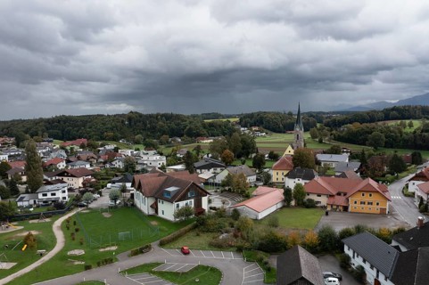 Drone shot, view of village with parish church, Rutzenmoos, Hausruckviertel, Upper Austria,