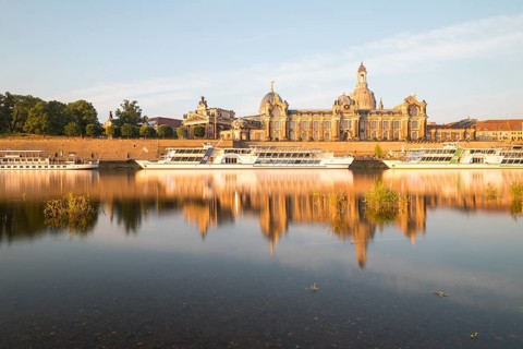 Silhouette of the Old Town with reflection in the Elbe in the morning, steamboats on the