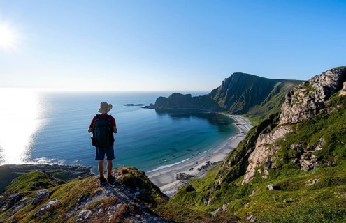 Mountaineer, view of coastal landscape, steep coast with summit Måtind or Måtinden, Høyvika beach