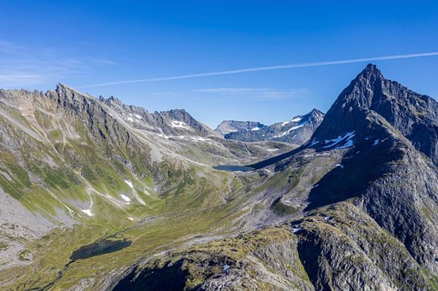 Aerial view of a glacial, u-shaped valley and peak of Mt. Slogen, above village Urke at the