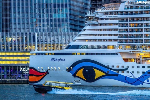 Cruise ship Aida Prima at the Cruise Terminal of Rotterdam, Kop van Zuid, skyscrapers at the
