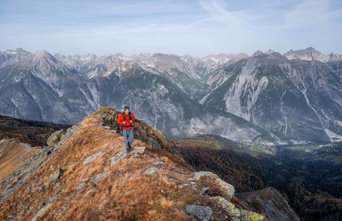 Mountaineer in front of a mountain panorama on a mountain ridge, view from the ridge of the Venet