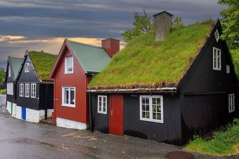 Traditional black tarred wooden houses with turf roofs at Reyn, Tinganes, old town of Tórshavn,