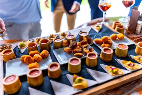 Gourmet appetizers beautifully arranged on a tray at a wedding reception, featuring various finger