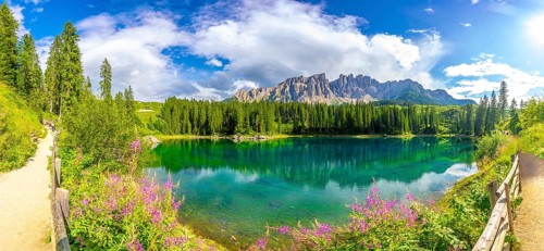 Panoramic view of the beautiful lake carezza with the latemar mountain range in the background on a