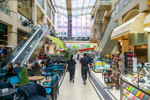 Shops and people inside shopping mall Galeria 17 Nëntori in city centre, Tirana, Albania, Europe