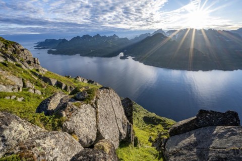 View of Fjord Raftsund and mountains in the evening light, sun star, view from the top of