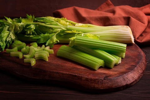 Fresh bunch of celery, top view, no people, on a dark background