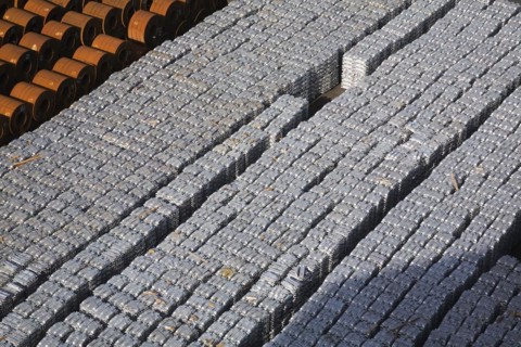 Top view of aluminium ingots and coils of flat rolled steel waiting for shipment at a terminal in