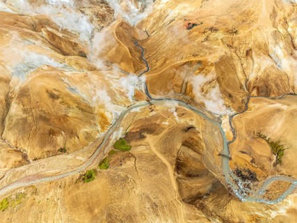Steaming hot springs and colourful rhyolite mountains, aerial view, Hveradalir geothermal area,